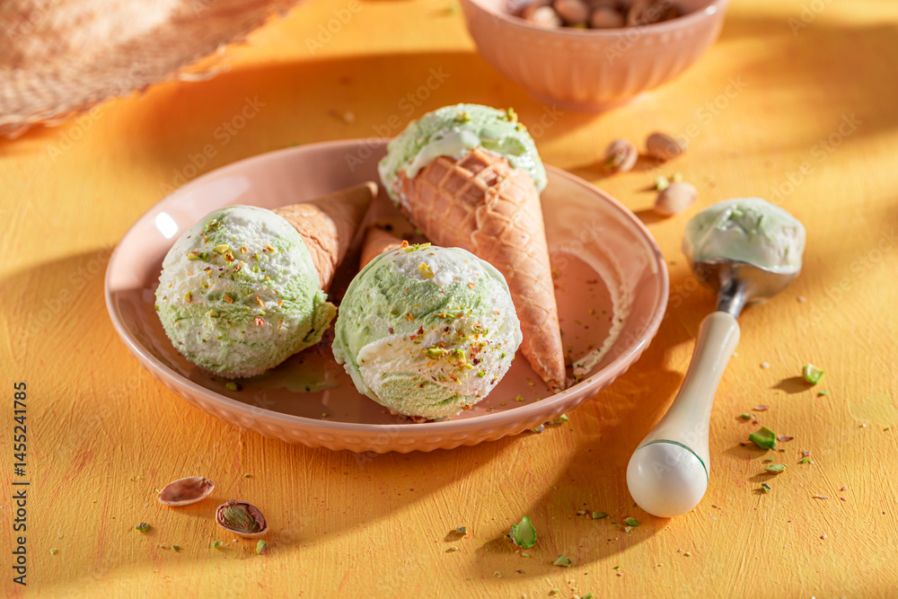 Fresh and tasty pistachio ice cream in a waffle cone.