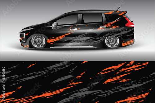 Sleek black car with orange graphic design in motion
