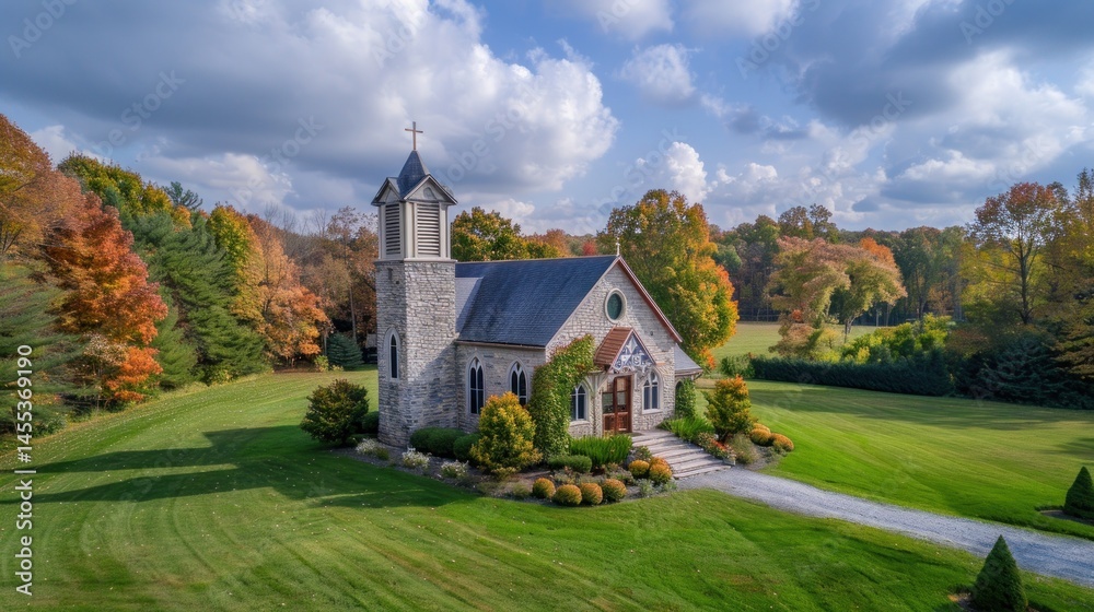 Fototapeta premium Autumnal stone church nestled in a park-like setting