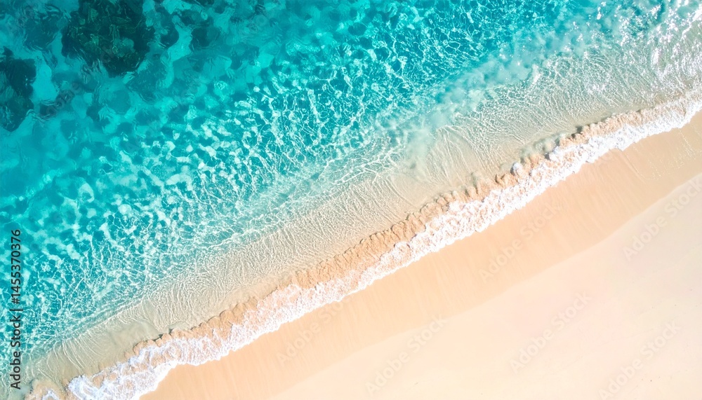 Obraz premium Clear turquoise water on sandy beach, top view image