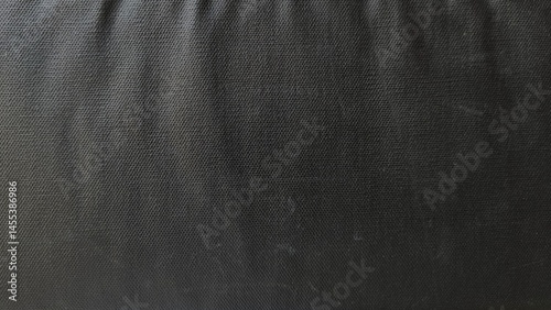 Black netting cloth material fragment as a background texture composition