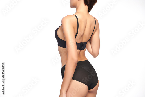 Confident beautiful young asian woman posing in black lingerie on white background, Perfect body,