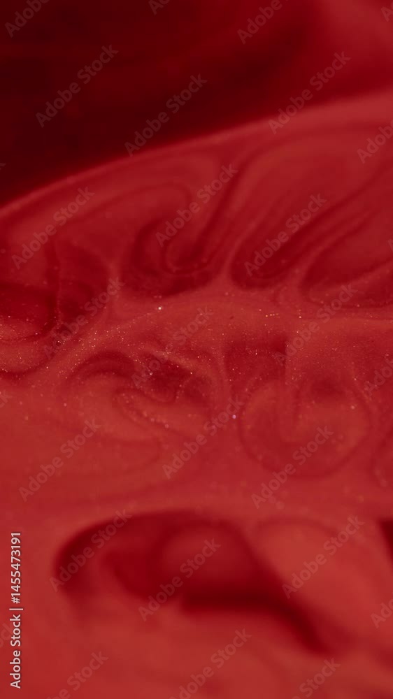 Vertical video. Marble spill. Paint flow. Red smooth wide stream stone effect with dissolving dye in opaque liquid. Wavy gleam glitter enamel morphing emulsion.