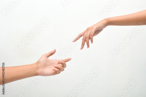 male and female hands reaching towards each other on isolated white background