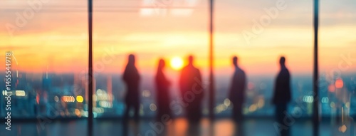 Blurred Silhouettes of Business Team Meeting in Modern Office at Sunset