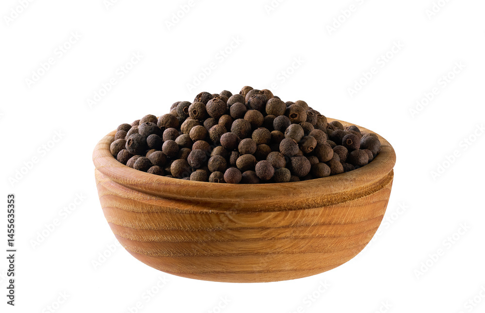 allspice or Jamaican pepper seeds in a wooden bowl isolated on white background. allspice or Jamaican pepper seeds in a wooden bowl isolated on white background.