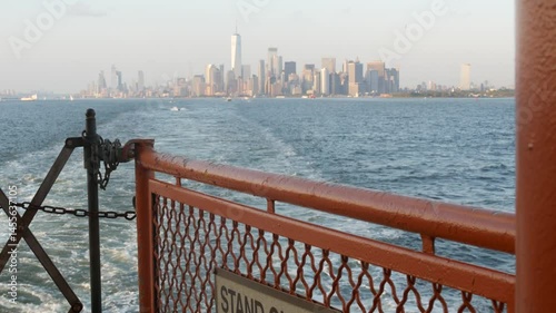 New York City skyline from ferry boat to Staten Island. Manhattan downtown. World Trade Center skyscraper from ferryboat. River waterfront sunset panorama, riverfront buildings architecture, FiDi, USA