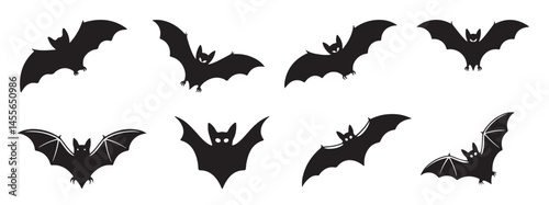 Set of bat silhouettes in various flying poses, isolated on white background for Halloween or nature themes  
