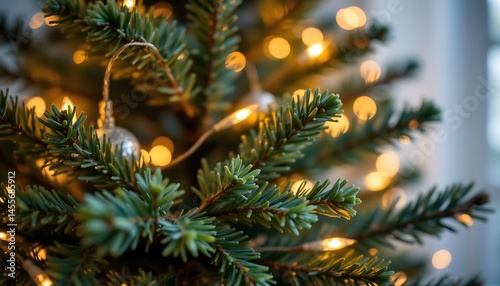 a blurred image of an artificial pine christmas tree adorned with bokeh led decorative lights, creating a festive defocused background
