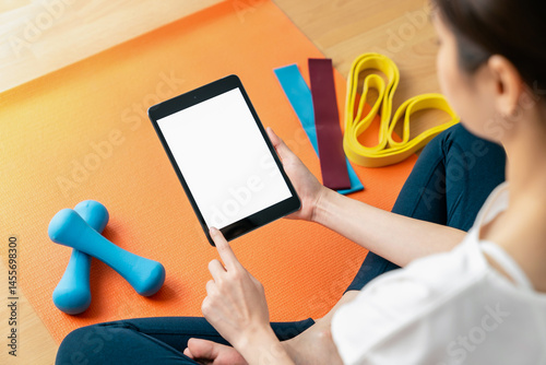 Woman doing exercise yoga plank and blank screen on digital tablet, for putting advertising to promote.