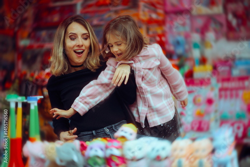 Little Girl Wants to Buy Toys Against the Advice of her Mom. Mother tries to control her child from impulse buying 