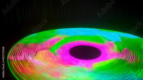 Vibrant, swirling light painting in green, pink, and blue, creating a circular, hypnotic effect on a dark background