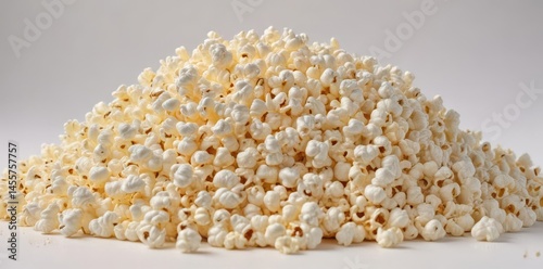 A fluffy mound of popcorn against a pure white backdrop , buttery, macro