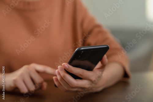 Hand holding smartphone with using social media.