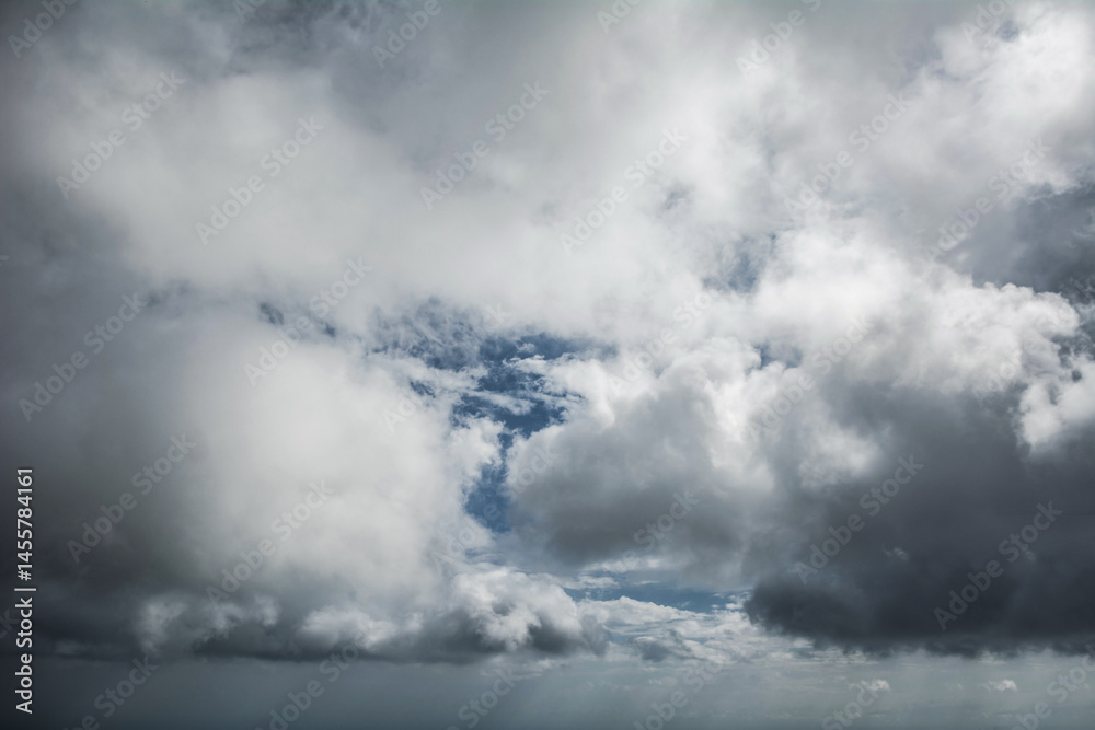 Dramatic cloudy sky with thick gray clouds and patches of blue, natural weather background panorama. Dramatic cloudy sky with thick gray clouds and patches of blue, natural weather background panorama.