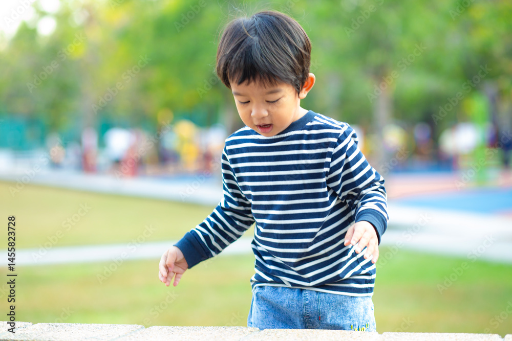 Happy adorable little 3 year boy running on green grass in morning park Happy adorable little 3 year boy running on green grass in morning park
