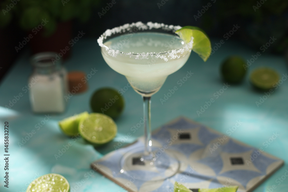 A glass with margarita cocktail with lime