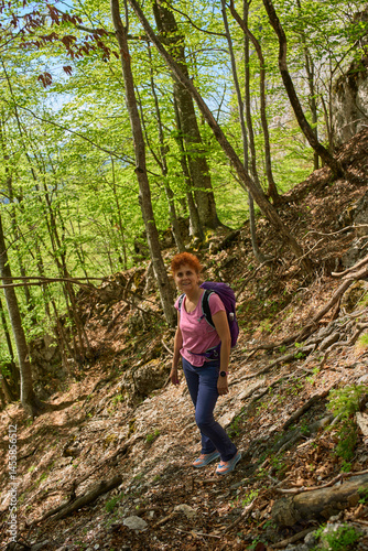 Woman hiking on forest slope