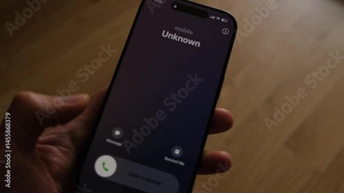 Fraud or fraudulent schemes. Close-up of a male hand holding a phone with an unexpected incoming call from an unknown