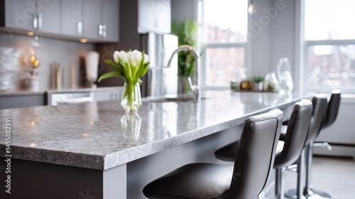 Sleek gray marble kitchen counter with modern bar stools, minimalist elegance in a contemporary home
