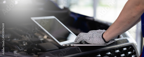 Close-up of a car diagnostic system in use, as a skilled mechanic carefully inspects engine data to provide precise maintenance and reliable repair services in a professional auto repair garage