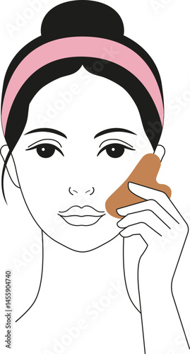 Woman doing facial massage with gua sha stone