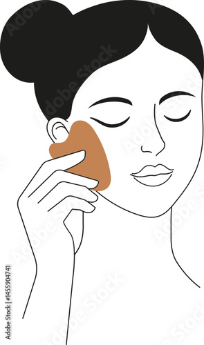 Woman doing facial massage with gua sha stone