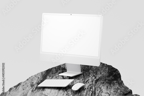 Clean computer setup on rocky mountaintop isolated