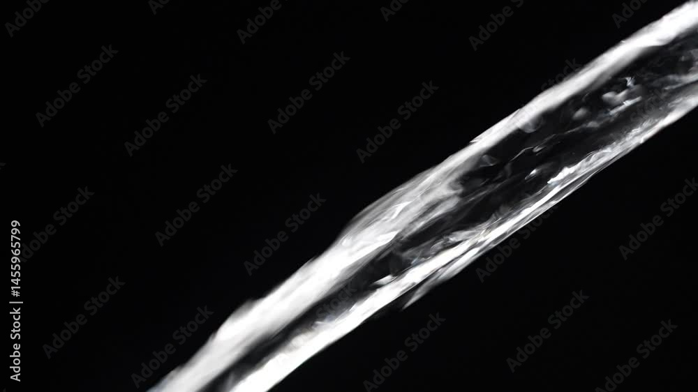 Crystal clear stream of water flowing on isolated black background, close up, slow motion. Transparent pouring stream of clean water cascading against a dark backdrop. Concept of drinking pure water Crystal clear stream of water flowing on isolated black background, close up, slow motion. Transparent pouring stream of clean water cascading against a dark backdrop. Concept of drinking pure water