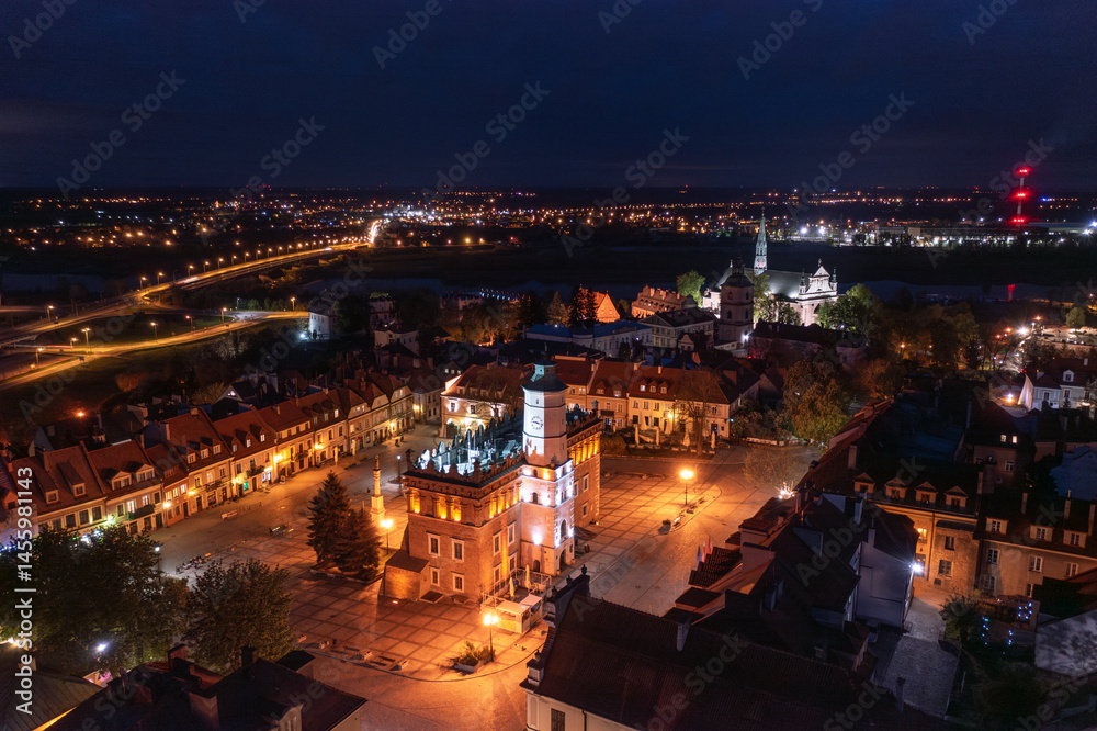 Summer skyline cityscape of Sandomierz, Świętokrzyskie, Poland. Wide panoramic aerial night view of the illuminated old town.