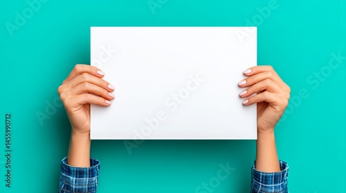 Hands Holding Blank White Paper on Turquoise Background