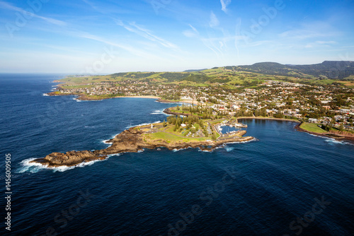 The beautiful coastal town of Kiama, located just south of Sydney featuring the well known lighthouse, blowhole and scenic boat harbour. Captured from high above a dark blue pacific ocean.