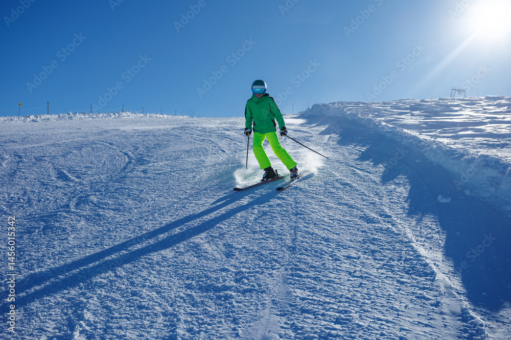 Wearing bright gear, skier navigates the snowy descent swiftly
