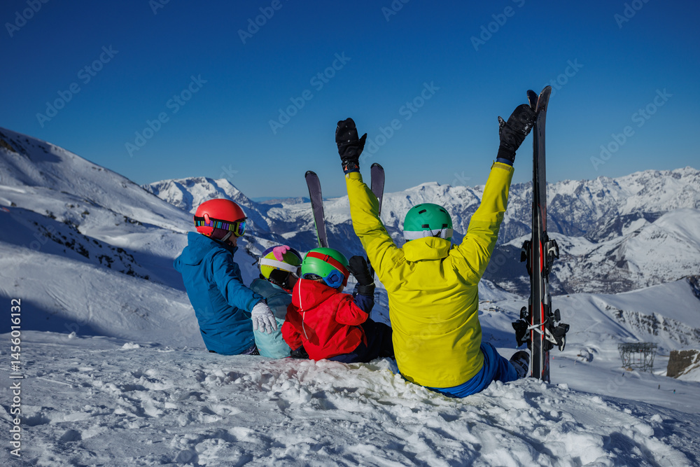A joyful family lift hand have fun moments in snowy mountain