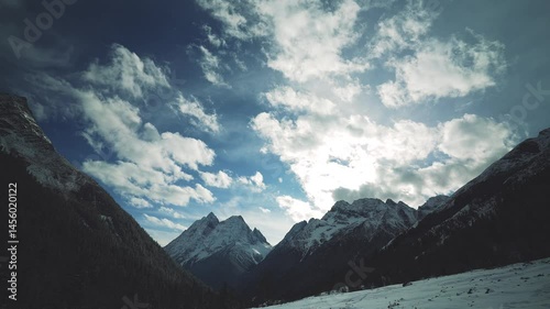 Blue sky, sunlight day, Siguniang mountain or Four sister mountain with snow cap on top in January, winter season in Sichuan, China
