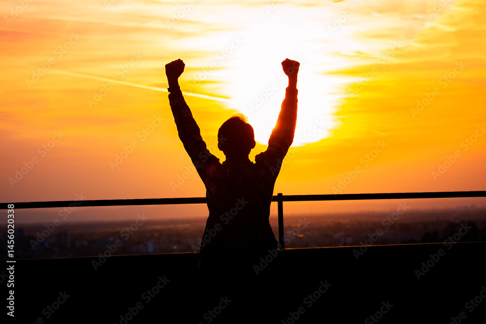 Fototapeta premium Male tourist on top of mountain backpacking raise hands feel the sun shining in the evening, successful concept