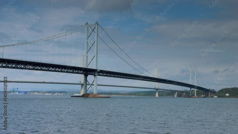 Slow pan of the Forth Road Bridge and Queensferry crossing spanning the 'Forth of firth' in Scotland Slow pan of the Forth Road Bridge and Queensferry crossing spanning the 'Forth of firth' in Scotland