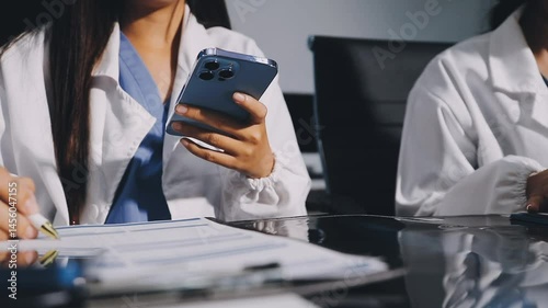 Medical co working concept,Doctor working with smart phone and digital tablet and laptop computer to meeting his team in modern office at hospital