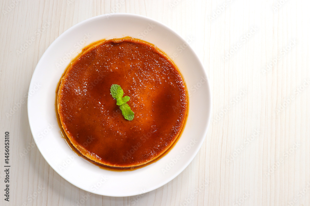 Delicious caramel custard with a glossy caramel top, served on a white plate. Perfectly lit, smooth texture, and minimal background. ideal for menus, blogs, packaging, or dessert features. Copy space Delicious caramel custard with a glossy caramel top, served on a white plate. Perfectly lit, smooth texture, and minimal background. ideal for menus, blogs, packaging, or dessert features. Copy space