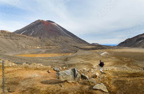 Obraz na płótnie Man hiking Tongariro Alpine Crossing towards Mt Ngauruhoe. Tongariro National Park. New Zealand. w salonie