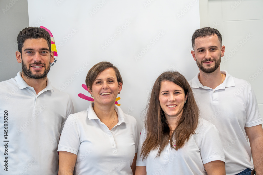 Four friendly Caucasian physiotherapists standing together in a healthcare facility Four friendly Caucasian physiotherapists standing together in a healthcare facility