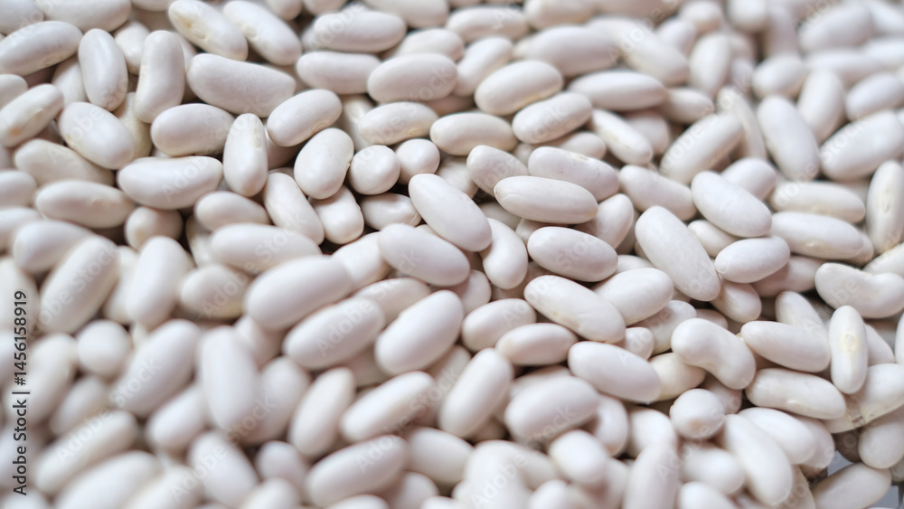 Close-up image of a large pile of white kidney beans, also known as cannellini beans. Close-up image of a large pile of white kidney beans, also known as cannellini beans.