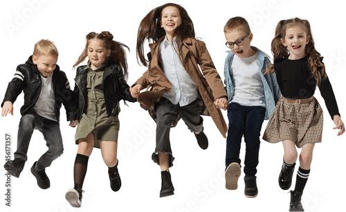 Obraz na płótnie Happy childhood. Emotional school and preschool age children, girls and boys running, jumping isolated on transparent background. Beauty, kids fashion, ad, education, friendship concept. w salonie