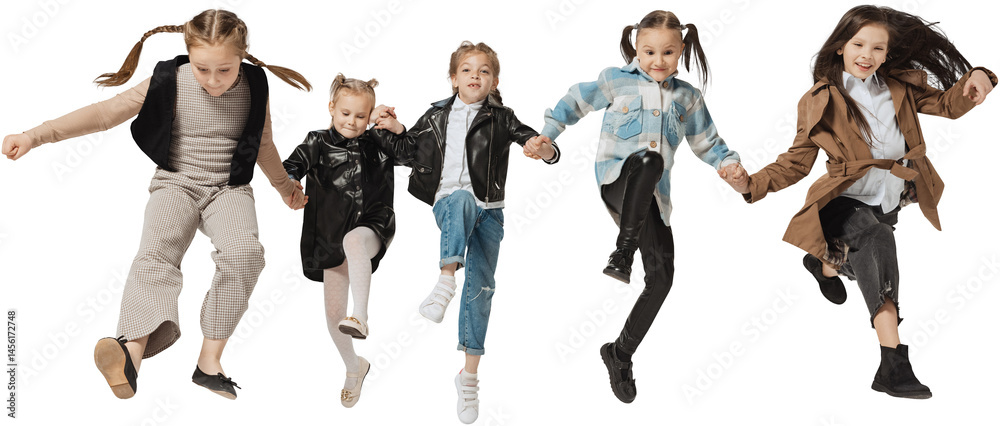 Happy school and preschool age children, girls and boys running, jumping isolated on transparent background. Beauty, kids fashion, ad, education, happy childhood concept.