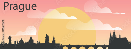 The skyline of the city of Prague, Czech Republic on the background of the big yellow sunset on the pink sky with clouds.