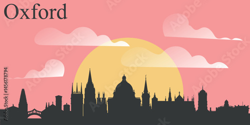 The skyline of the city of Oxford, England on the background of the big yellow sunset on the pink sky with clouds.