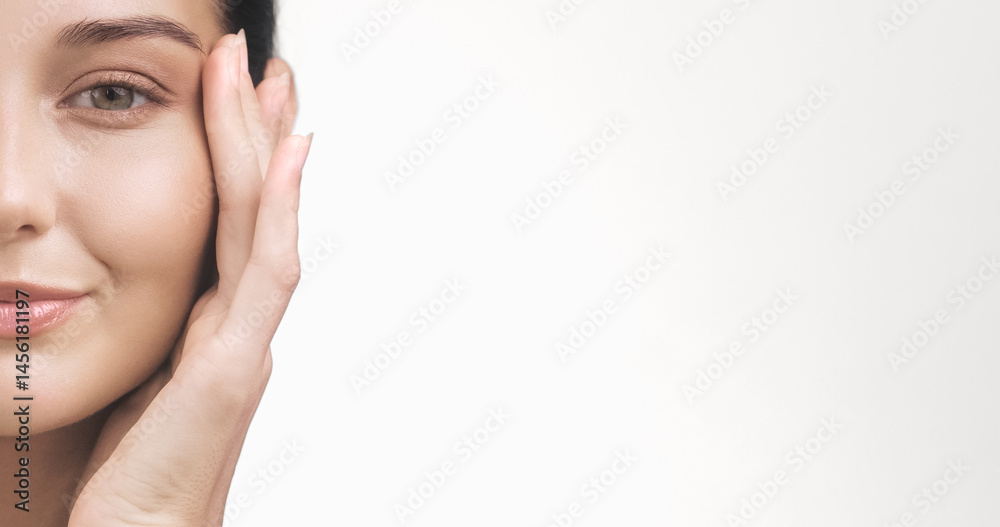 High-quality close-up of a woman s glowing face with hand touching cheek and ample white space for promotional text. Perfect for skincare ads, banners, wellness branding, and cosmetics.