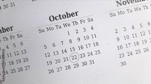 marking  22 October date on the calendar	
