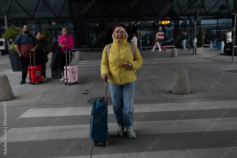 Senior female tourist in airport hold suitcase valise passport ticket schedule to check flight departure gate. Travel and tourism concept, people with backpack on shoulders. High quality photo