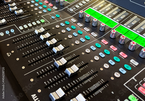 Sliders and buttons on Audio Mixing Desk at live event..
